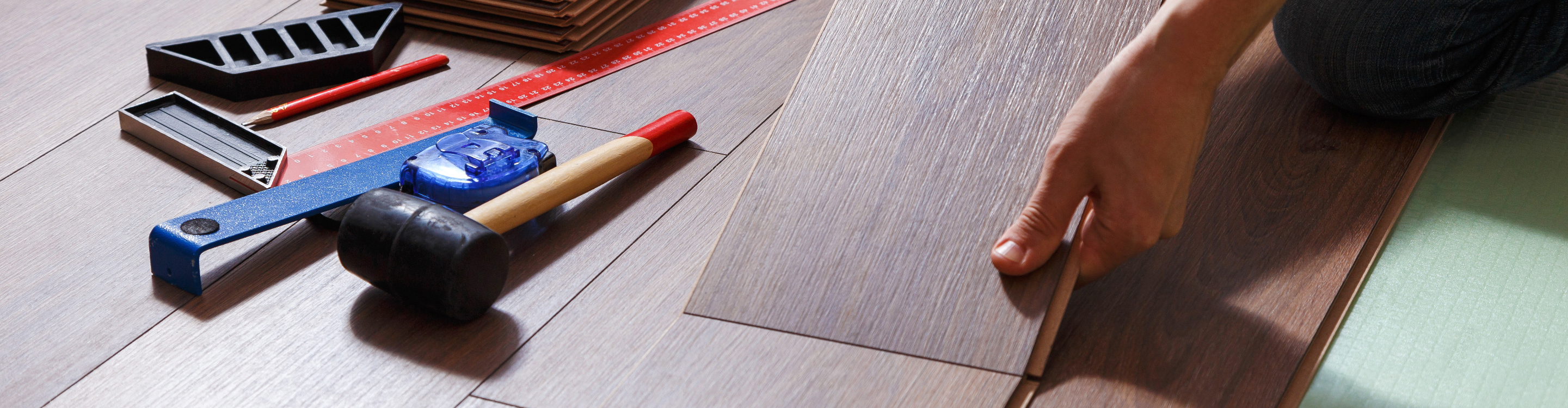 Flooring installation closeup with tools. 